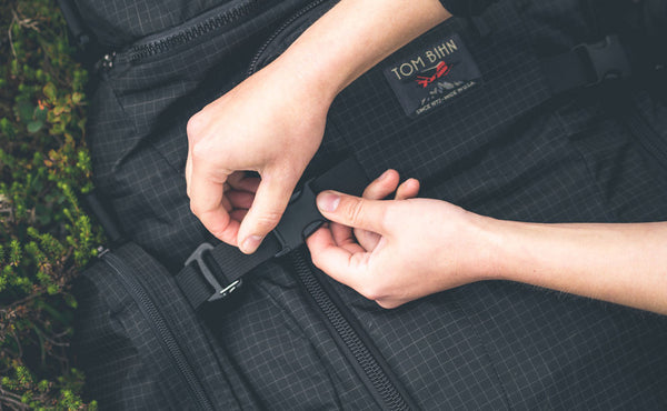 A person securing a buckle on the Hero's Journey.